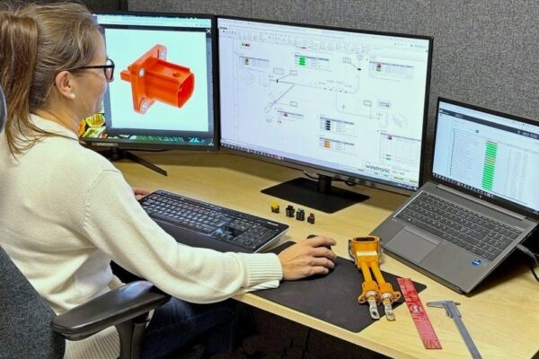 Woman by computer with CAD drawing